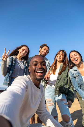 smiling-multiracial-friends-take-selfie-looking-camera-copy-space-vertical-image-friendship-social-media-concept_411082-992